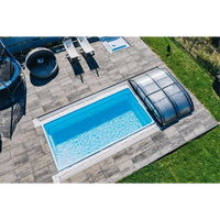 Glasfiberpool Papeete med klart blått vatten och transparent lock på grå stenplattor